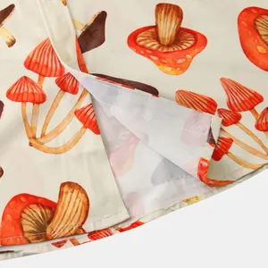 Close-up of the hem and vibrant mushroom print fabric on a men's summer casual shirt