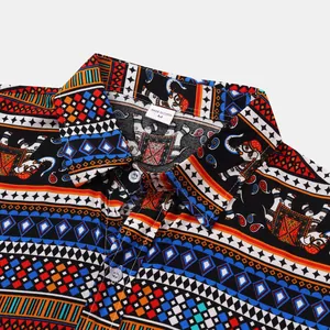 Macro detail shot of men's short sleeve shirt with vibrant ethnic elephant print pattern