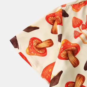 Close-up of vibrant red mushroom print on men's casual short-sleeved shirt fabric