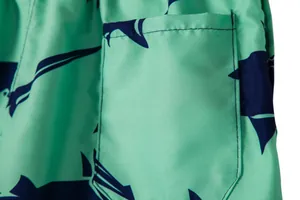 Detailed view of the pocket and shark print on these breathable men's beach swim shorts