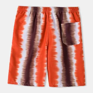 Back view of orange tie-dye beach shorts featuring elastic waist and rear patch pocket