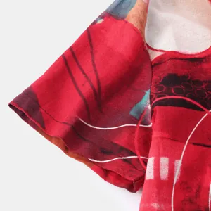 Close-up of men's ethnic style casual shirt sleeve with red abstract print detail