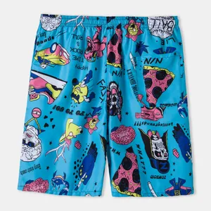 Close-up of vibrant cartoon and punk graphic patterns on breathable blue beach shorts