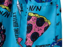 Close-up of blue men's beach shorts with vibrant pizza and cartoon prints on fabric