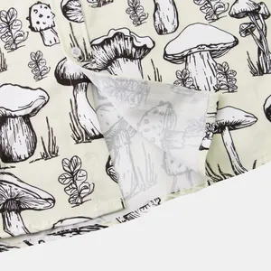 Detailed close-up of a men's casual short sleeve shirt with artistic mushroom print pattern.
