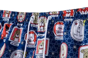 Detailed view of men's quick-dry beach shorts with cartoon dog print and white drawstring
