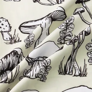 Detailed macro view of hand-drawn mushroom print on soft casual men's shirt fabric