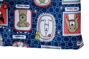 Close-up detail of cartoon dog print on blue hexagonal pattern beach shorts