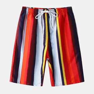 Detail of colorful vertical striped men's beach shorts with adjustable white drawstring waist.