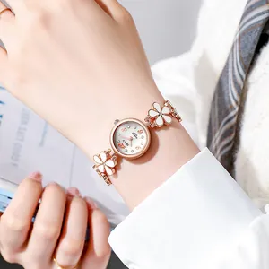 Close-up of elegant women's rose gold watch with floral bracelet strap
