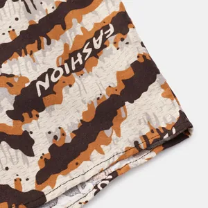 Close-up detail of the ethnic floral print and fabric texture on a men's casual shirt