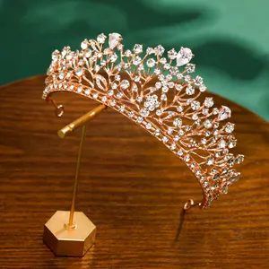 Elegant close-up of rose gold bridal crown with sparkling white rhinestones on a display stand