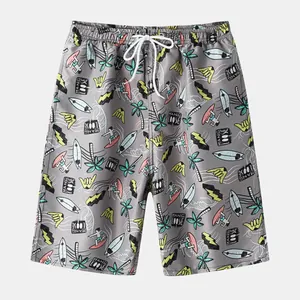 Detailed view of men's beach shorts featuring surf-themed graphic prints and drawstrings
