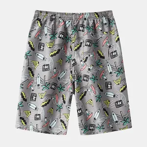 Macro view of men's quick-dry beach shorts featuring a colorful surfboard print