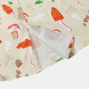 Detailed view of stitching and vibrant mushroom pattern on men's casual short sleeve shirt