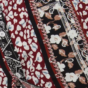 Close-up detail of patchwork floral and leopard print fabric on men's short sleeve shirt