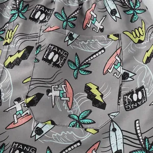 Close-up of men's beach shorts featuring a surf-themed print and a functional back pocket.