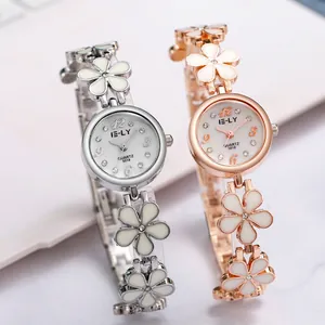 Close-up of elegant silver and rose gold floral bracelet watches with quartz dial design