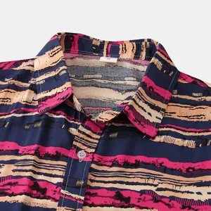 Close-up detail of a men's short-sleeved shirt with an artistic colorful striped pattern