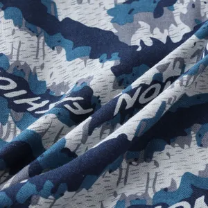 Detailed macro view of men's casual shirt fabric featuring a blue camouflage print