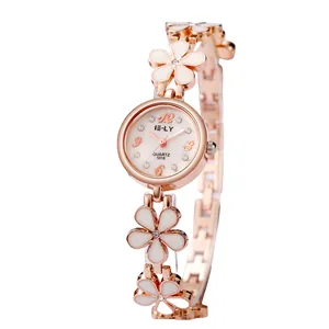 Rose gold women's floral bracelet watch with white enamel petals and crystal accents