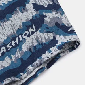 Detailed macro view of camouflage pattern fabric and double stitching on mens shirt