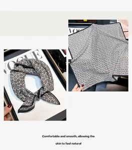 Detailed view of a vintage black and white silk cotton square scarf with paisley pattern.