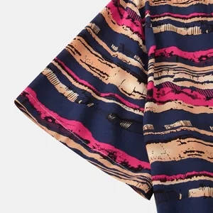 Macro view showing the fabric texture and short sleeve detail of navy blue and pink striped shirt