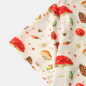 Close-up of mushroom and pine cone botanical print on men's short sleeve shirt