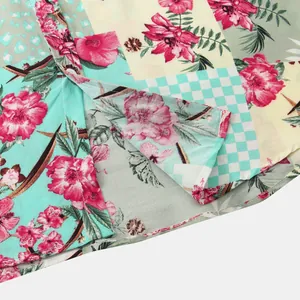 Macro view showing the fine stitching and vibrant floral patchwork pattern on summer shirt.