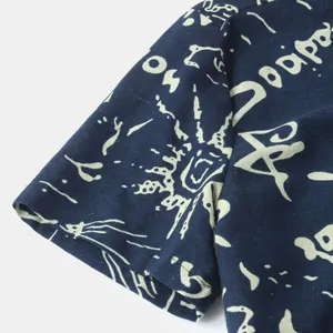 Close-up of ethnic floral print sleeve detail on navy blue casual men's cotton shirt
