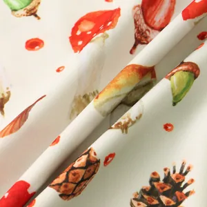 Detailed macro shot of premium shirt fabric featuring vibrant autumn acorn and pinecone prints