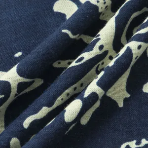 Close-up of ethnic style fabric texture showing navy and beige abstract pattern detail