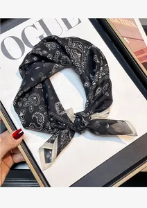 Detailed macro view of a silk-cotton blend square scarf with a classic paisley pattern.