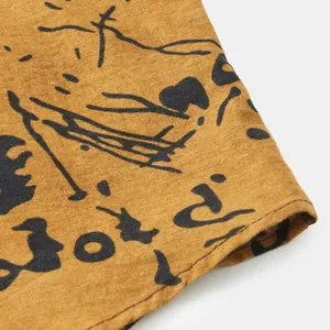 Detailed close-up view of mustard yellow ethnic print fabric on casual men's long sleeve shirt