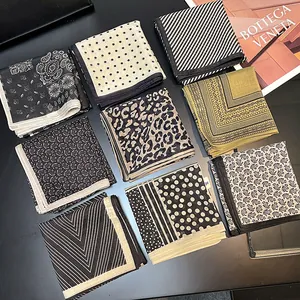 Collection of vintage black and white silk cotton square scarves with various patterns.