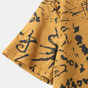 Detailed macro view of ethnic print fabric and sleeve hem on mustard casual shirt for men