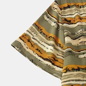 Close-up of sleeve on men's striped shirt with abstract earth-toned patterns