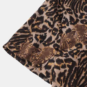 Close-up view of leopard print pattern and high-quality fabric texture on a casual shirt sleeve