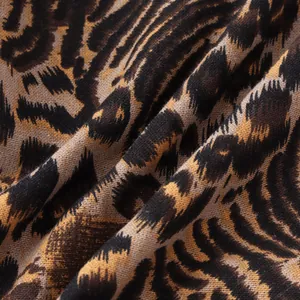 Macro detail showing the leopard print pattern and woven texture of the men's shirt