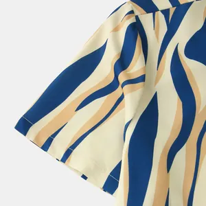 Detailed view of men's casual short-sleeve shirt with blue and tan abstract pattern