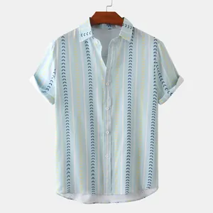Detail of men's short-sleeve shirt featuring blue vertical stripes and geometric prints.