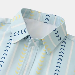 Detailed close-up of a men's light blue shirt collar with yellow and navy arrow prints.