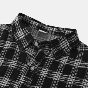 Detailed close-up view of the black and white plaid shirt collar and white buttons