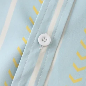 Close-up of white button and blue striped fabric on a men's slim casual short-sleeved shirt
