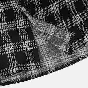 Close-up of black and white plaid shirt fabric showing stitching and a button detail