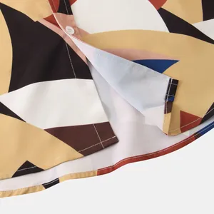 Detailed view of a men's casual shirt featuring a bold geometric abstract print pattern
