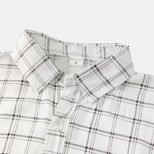 Close-up view of a white windowpane plaid shirt collar showing detailed fabric texture