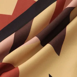 Macro detail of men's casual shirt fabric featuring a multicolor geometric chevron print