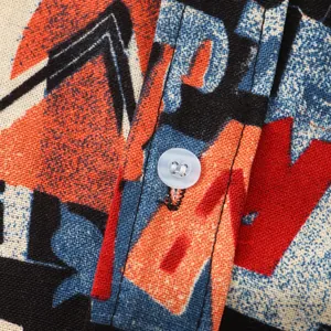 Close-up macro detail of the retro print fabric and white button on men's casual shirt
